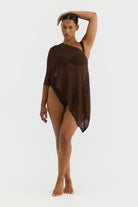 Woman wearing a brown sheer cover-up on a white background