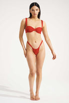 Woman wearing a red bikini on a white background