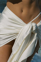 Close-up of a person wearing a white garment with a blurred background