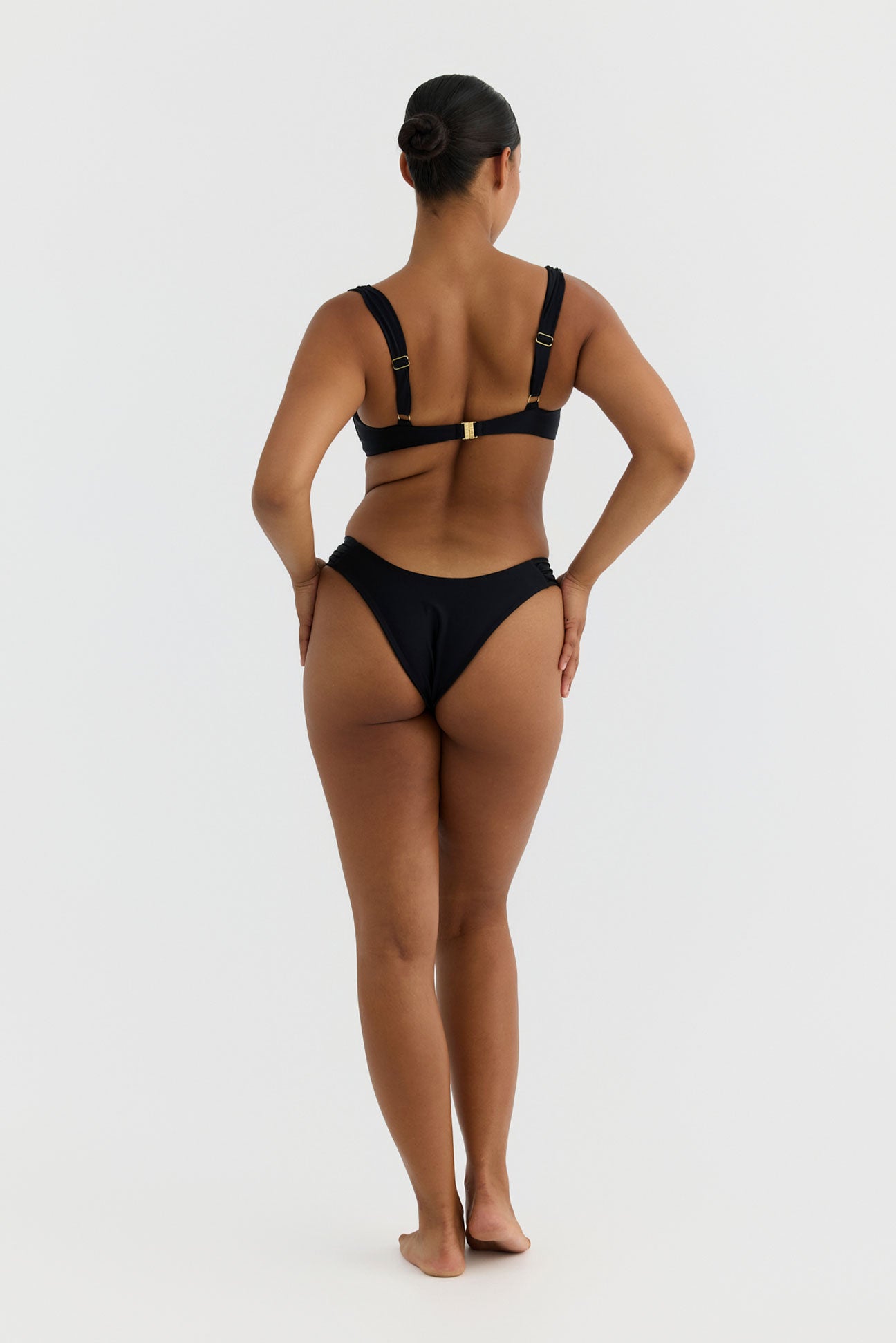 Person wearing a black bikini on a white background